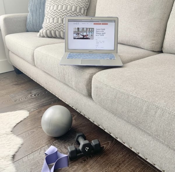 Laptop on sofa showing BR onDemand home barre workouts